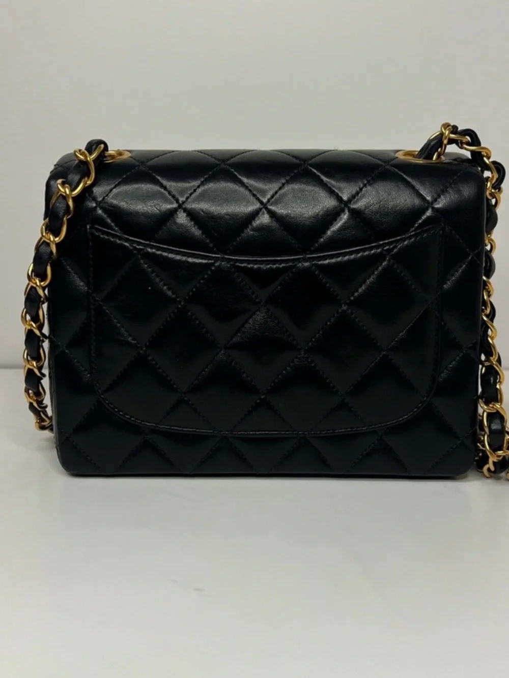 CHANEL Black Quilted Leather Mini Flap Bag with Gold Chain